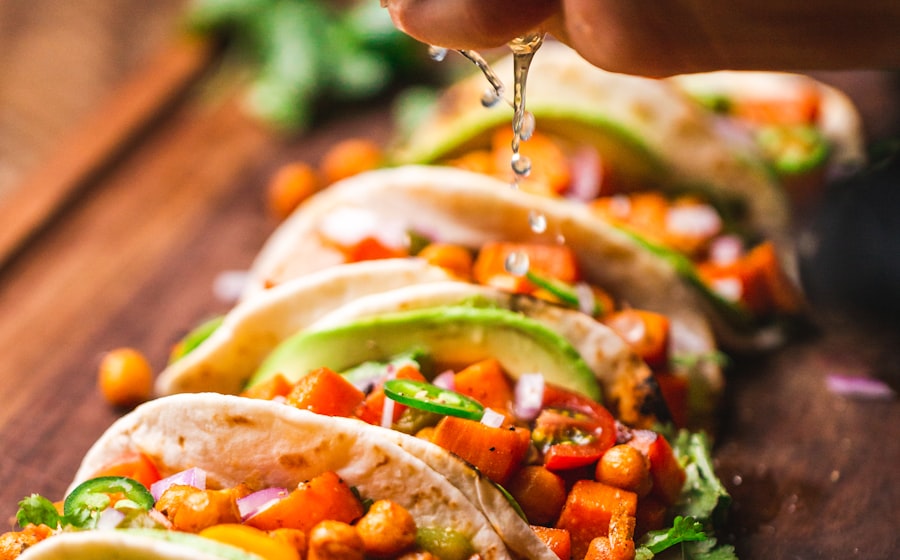 Close-up shot of a single enchilada on a fork showing the honey-glazed chicken filling with melted cheese stretching