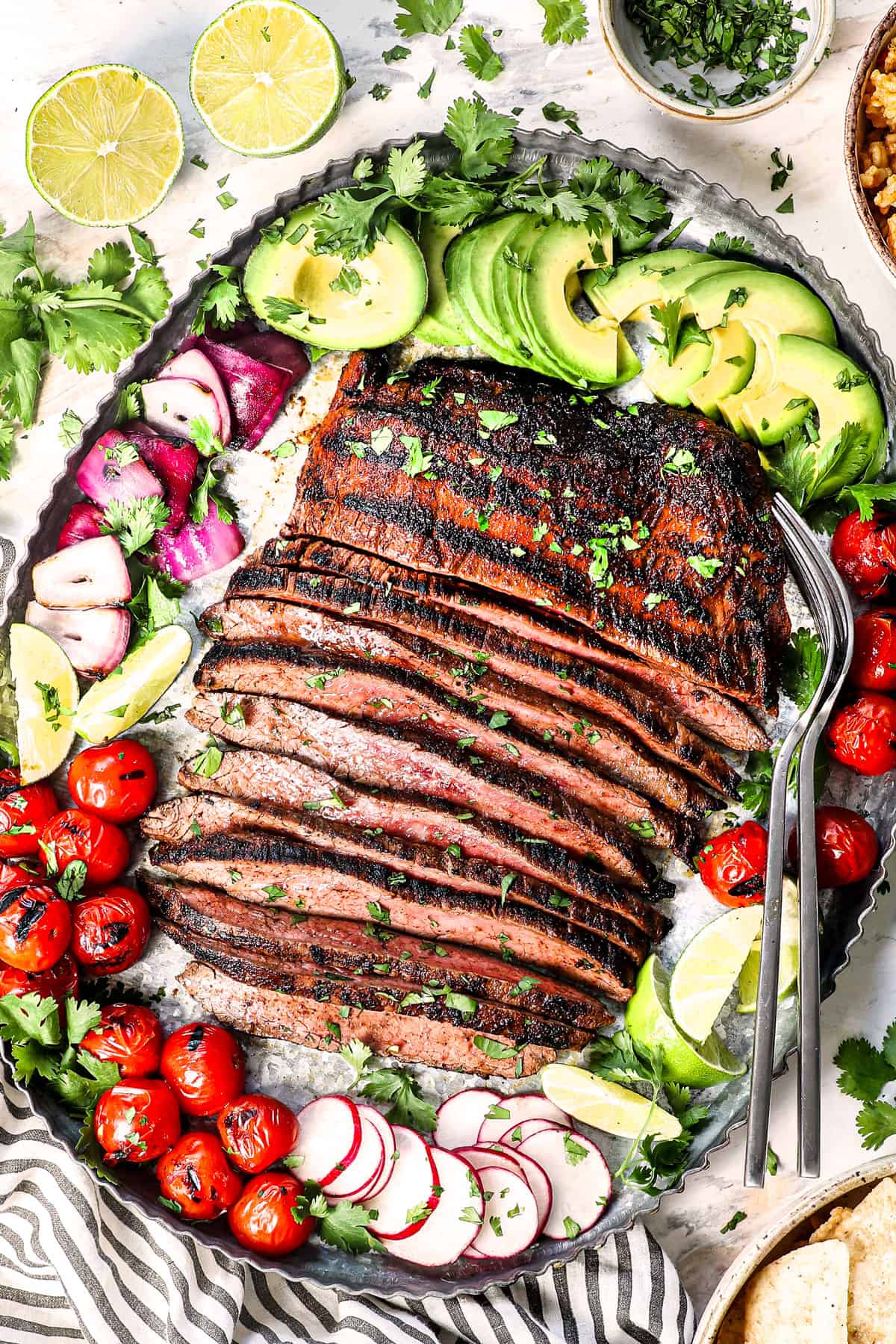 Close-up shot of sliced carne asada showing the perfect pink interior and charred exterior, garnished with fresh cilantro and served alongside warm tortillas