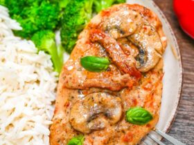 Marry Me Chicken served on elegant white plates with creamy sun-dried tomato sauce, fresh basil garnish, and golden seared chicken thighs
