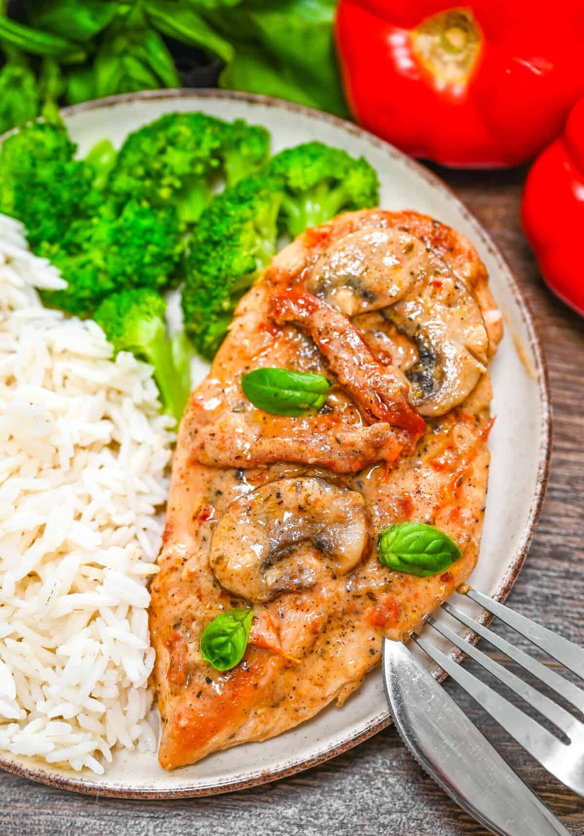 Marry Me Chicken served on elegant white plates with creamy sun-dried tomato sauce, fresh basil garnish, and golden seared chicken thighs