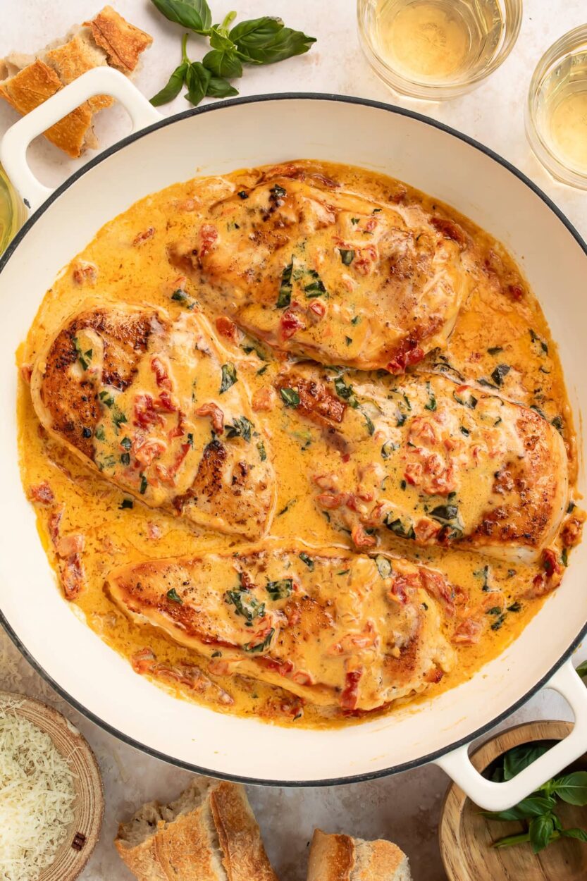 Close-up shot of a forkful of tender Marry Me Chicken with creamy sauce dripping, showing the rich texture and sun-dried tomatoes