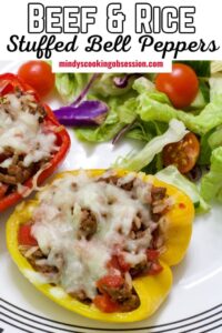 Stuffed bell peppers filled with cheesy ground beef and rice, golden melted cheese on top, plated on a white dish with fresh herbs