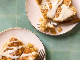 Overhead flat-lay of apple slab pie ingredients — sliced Granny Smith apples, brown sugar, cinnamon sticks, cold butter cubes, flour, and lemon on a marble surface