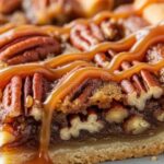 Pecan pie bars cut into neat squares on a wooden board, golden shortbread crust visible, glossy caramel pecan topping catching the light