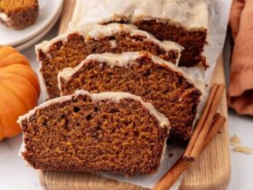 Close-up of a thick slice of pumpkin bread showing the moist, tender crumb interior with a golden crackly cinnamon sugar crust on top